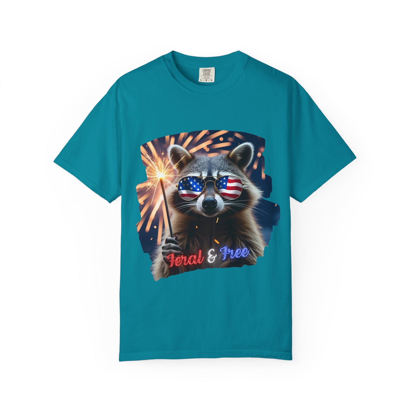 Stay wild in our “Feral & Free” tee! Featuring a raccoon rocking flag aviators, a sparkler in paw, and fireworks bursting behind—it’s pure chaotic patriotic energy for your summer vibe.