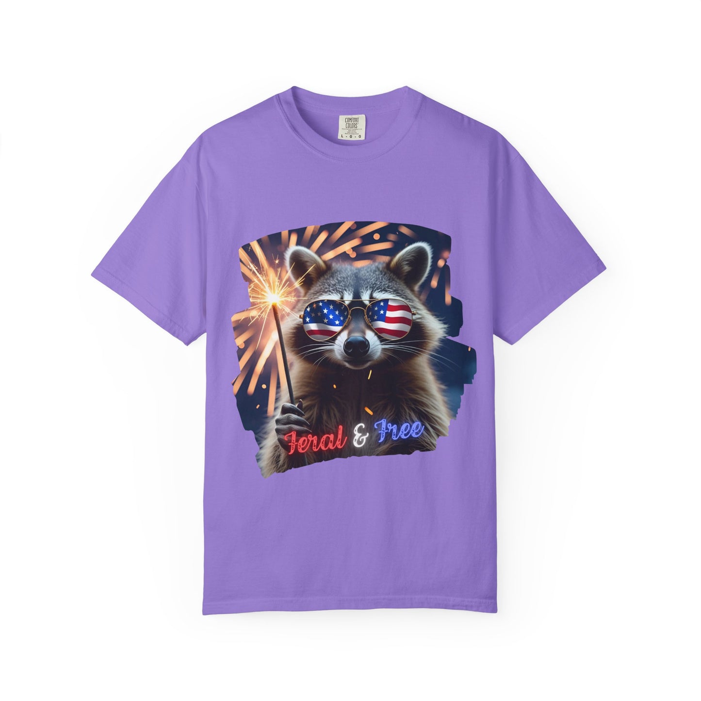 Stay wild in our “Feral & Free” tee! Featuring a raccoon rocking flag aviators, a sparkler in paw, and fireworks bursting behind—it’s pure chaotic patriotic energy for your summer vibe.