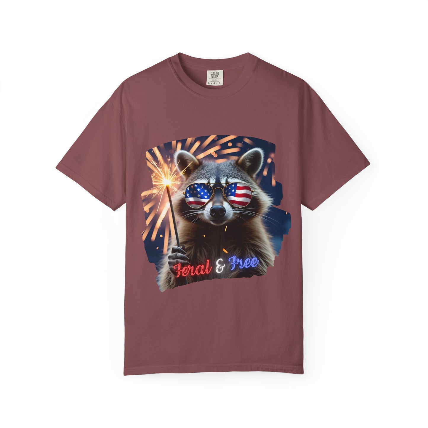 Stay wild in our “Feral & Free” tee! Featuring a raccoon rocking flag aviators, a sparkler in paw, and fireworks bursting behind—it’s pure chaotic patriotic energy for your summer vibe.